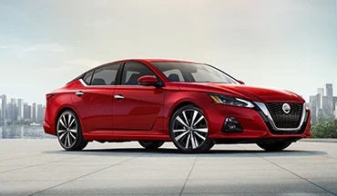 2023 Nissan Altima in red with city in background illustrating last year's 2022 model in Dave Syverson Nissan in Albert Lea MN