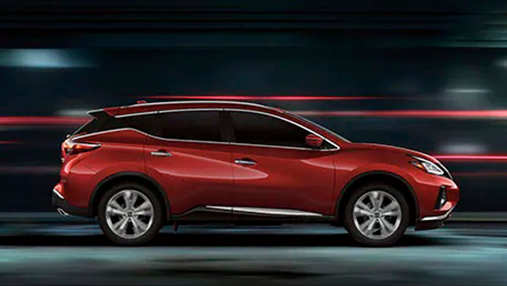 2023 Nissan Murano shown in profile driving down a street at night illustrating performance. | Dave Syverson Nissan in Albert Lea MN